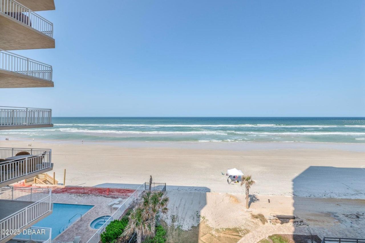 Photo 17 of 20: Take in spectacular views of the Atlantic Ocean, sandy shoreline, and rolling waves. The beachfront setting also offers views of the pool area below.
