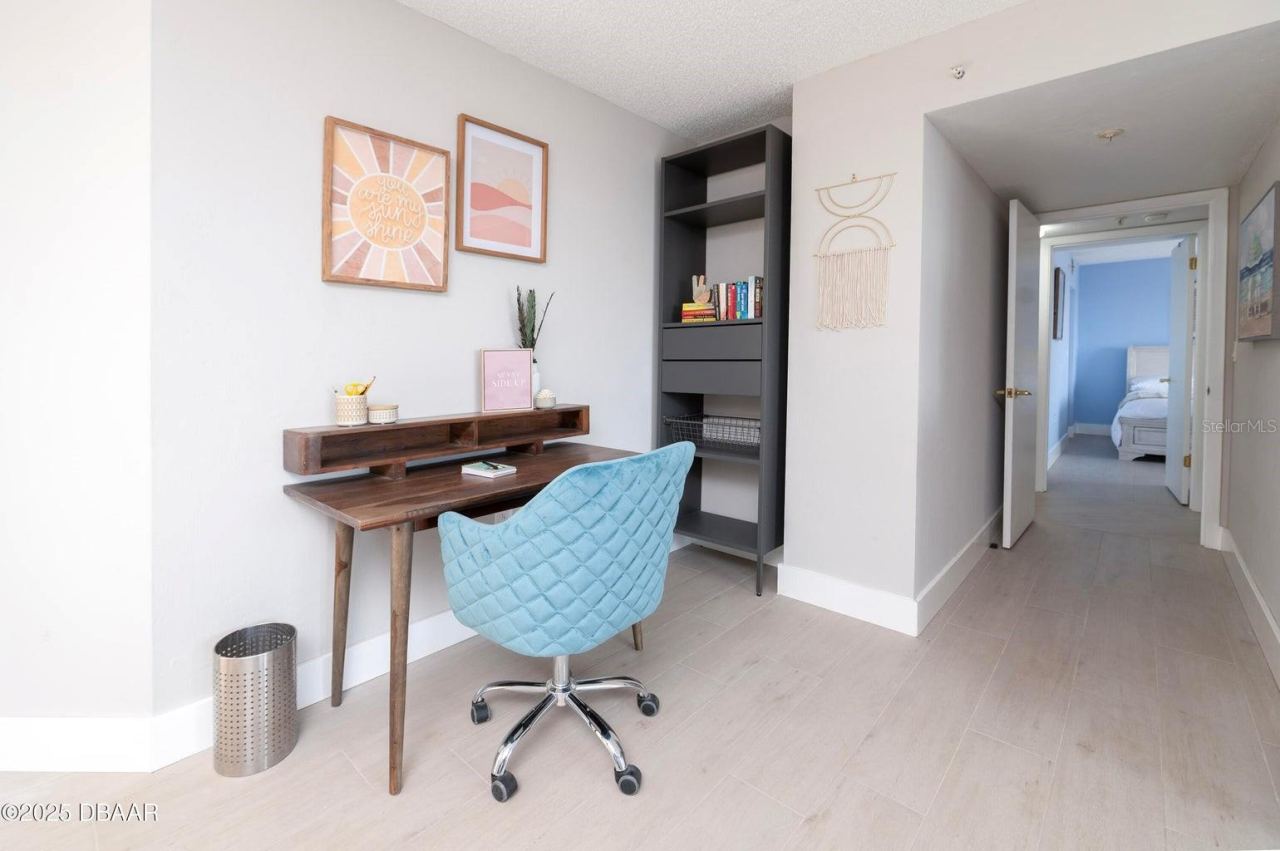 Photo 20 of 20: A convenient workspace within the primary suite offers room for a desk and shelving, providing a functional area for remote work, reading, or organizing daily essentials.