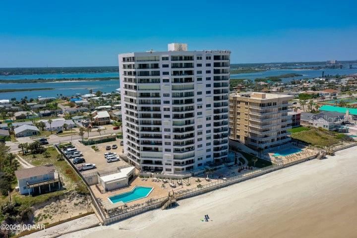 Photo 2 of 20: The property is set in a quiet, residential stretch of Daytona Beach Shores, surrounded by colorful beach homes and convenient local amenities.