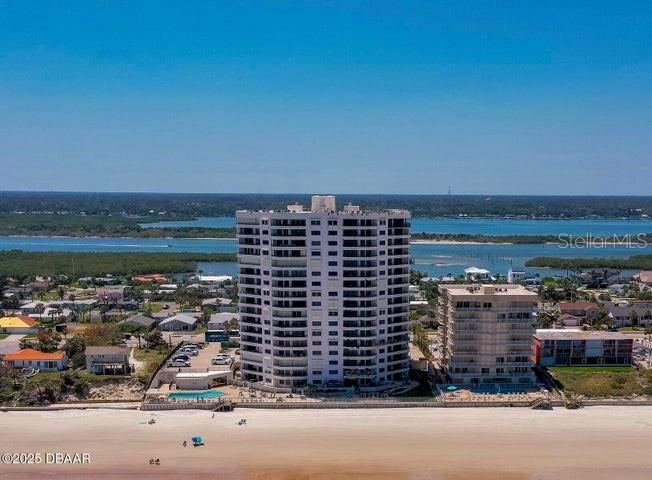 Photo 1 of 20: This oceanfront condominium offers panoramic views of the Intracoastal Waterway and surrounding community, with lush coastal landscapes stretching beyond the building.