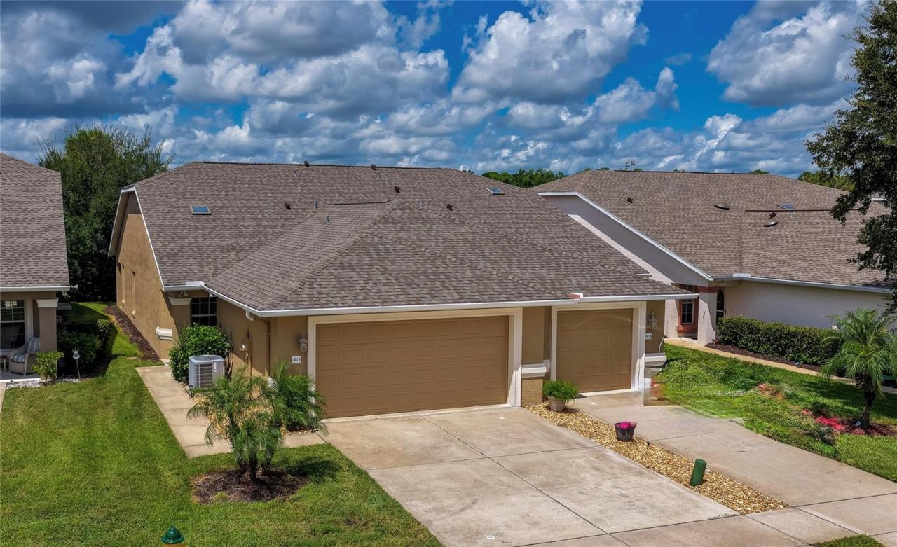 Photo 1 of 20: Charming home showcasing clean stucco finishes, attached garage , and a spacious concrete driveway. Simple, low-maintenance landscaping and lush green lawns complete the inviting curb appeal.