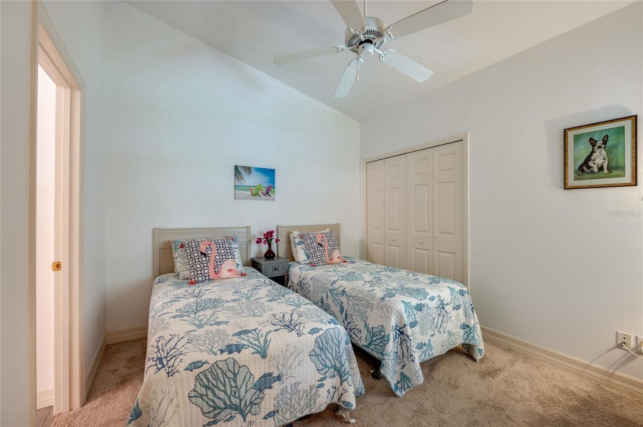 Photo 14 of 20: Bright bedroom showcasing vaulted ceilings, plush neutral carpeting, and a white ceiling fan. A bi-fold closet door accentuate the clean, airy layout.