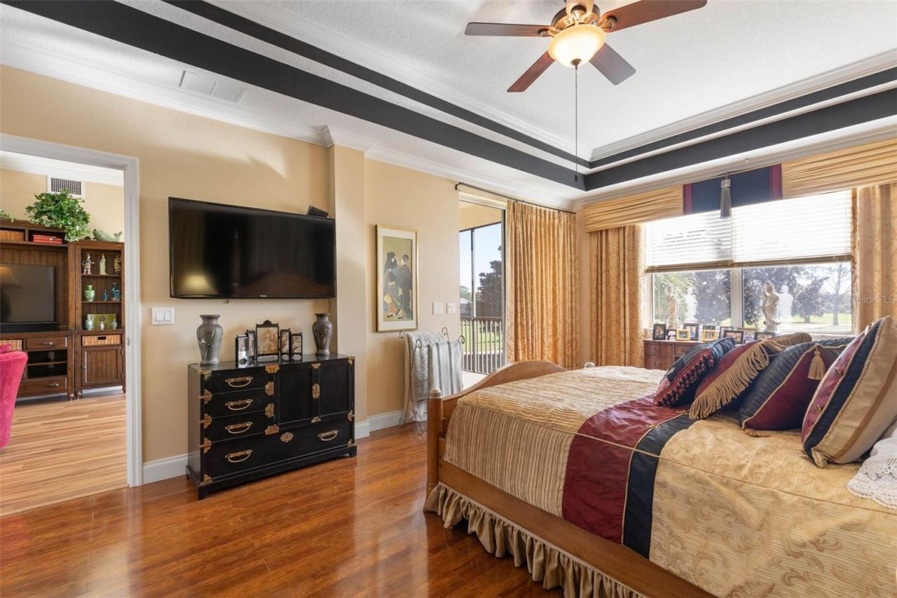 Photo 14 of 20: Primary bedroom with beautiful floors, slider to patio and plenty of sunshine!