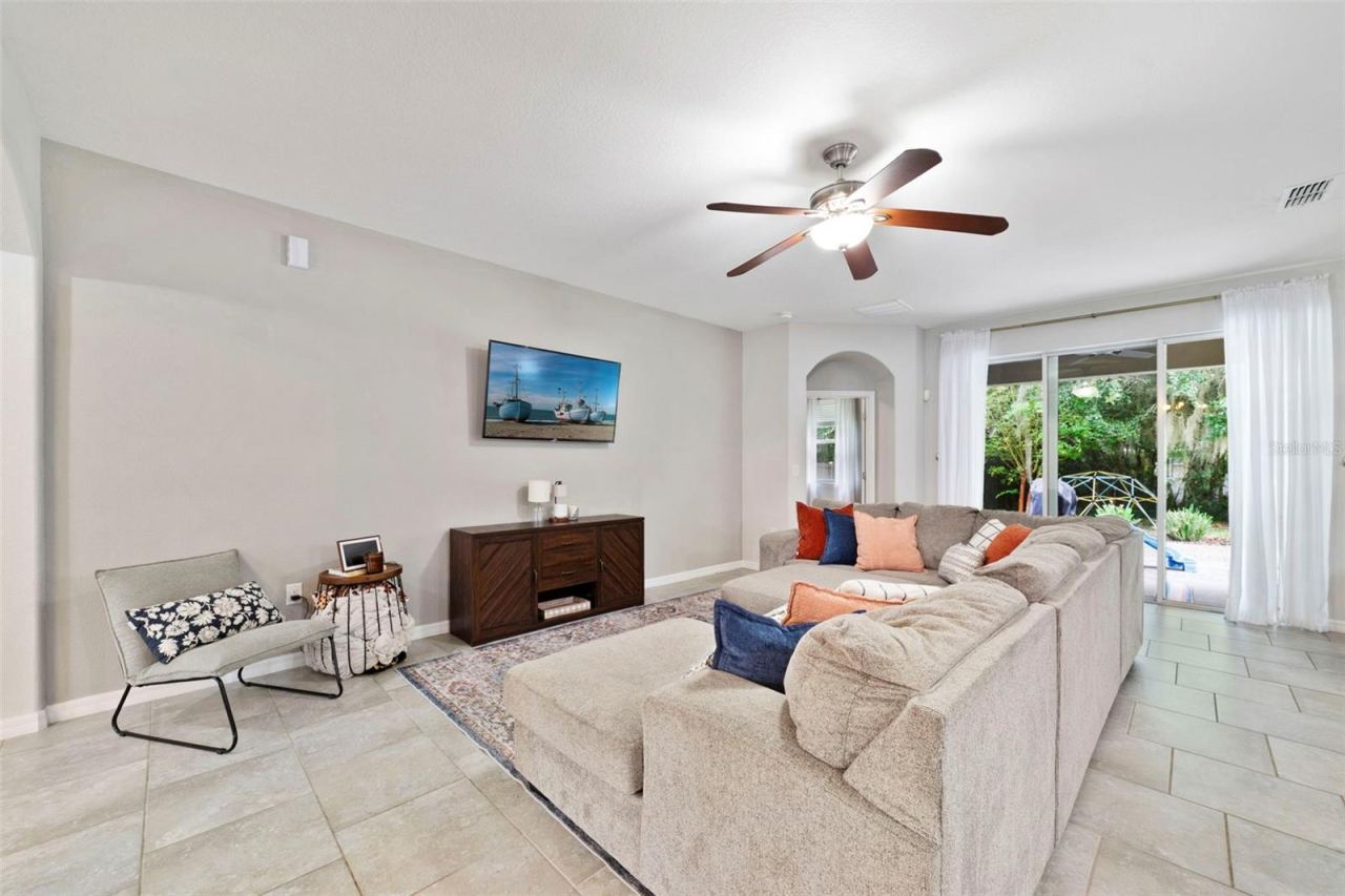 Photo 3 of 20: Living area has triple sliding glass doors that open up to the lanai.