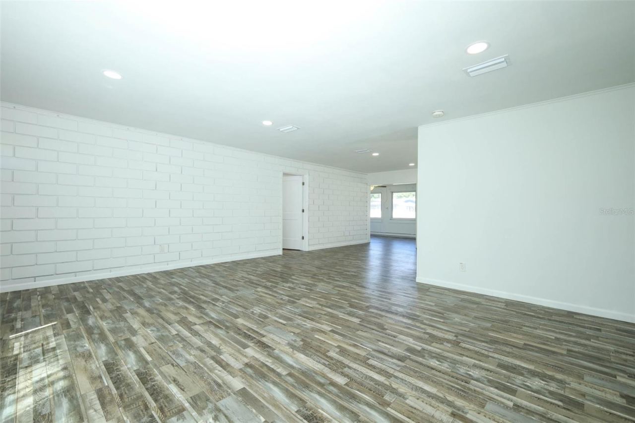 Photo 9 of 20: Living room looking into dining and Florida Room. Look at that brick wall!!