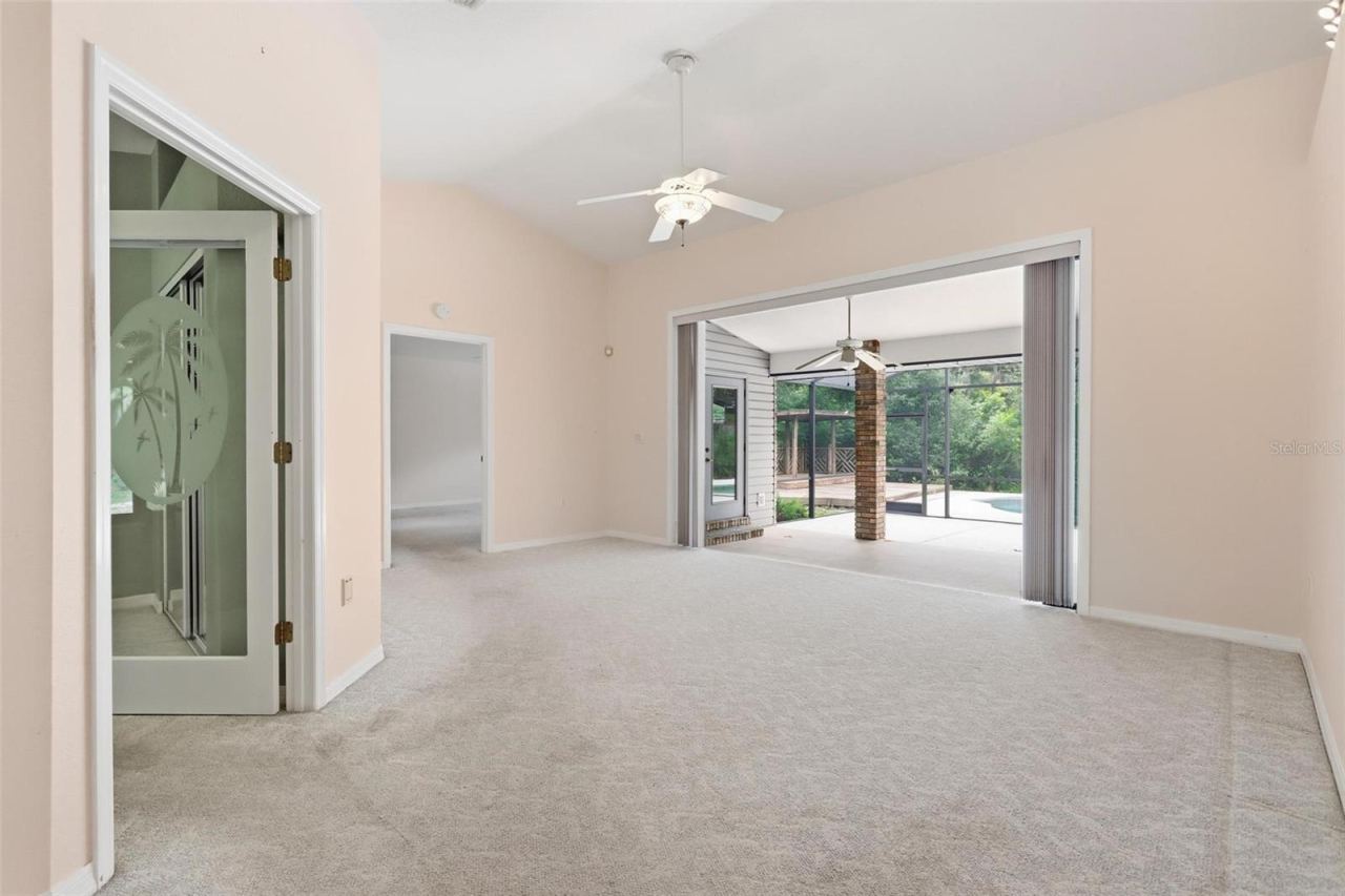 Photo 14 of 20: Sliding fully opened onto back patio. Office/bedroom #3 on right, primary straight ahead.