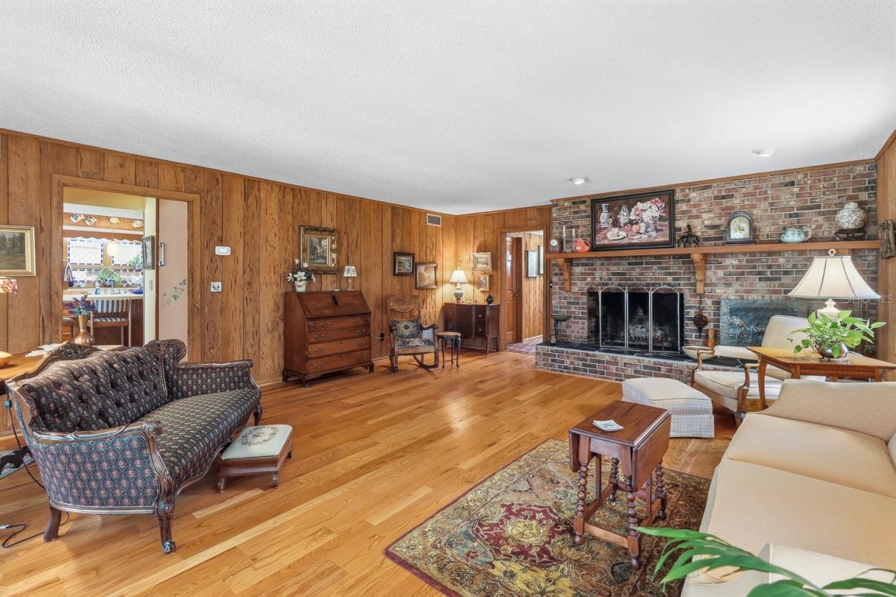 Photo 6 of 20: Formal living room with cypress walls and brick, wood burning fireplace.