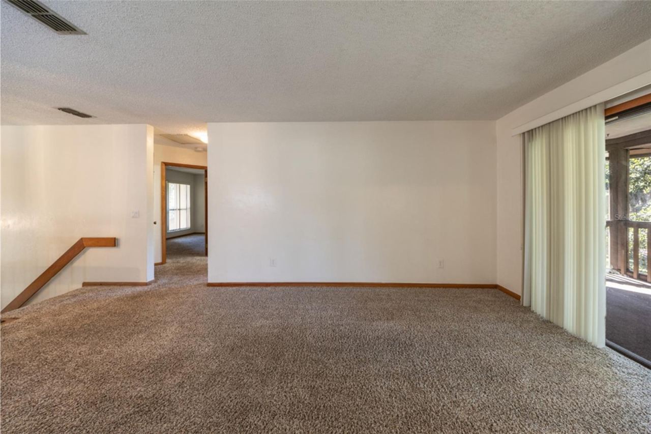 Photo 10 of 20: UNSTAGED: Carpeted Living Area. Professionally Cleaned