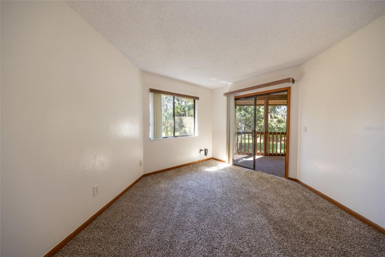Photo 16 of 20: Primary Suite With Sliders That Open To the Screened Patio