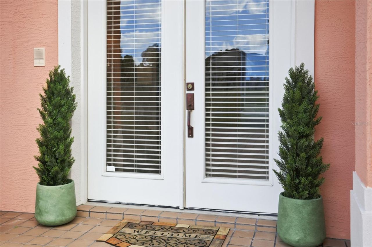 Photo 6 of 20: Glass double entry doors and a sheltered front porch welcome visitors to 226 AlexandraWoods Drive.