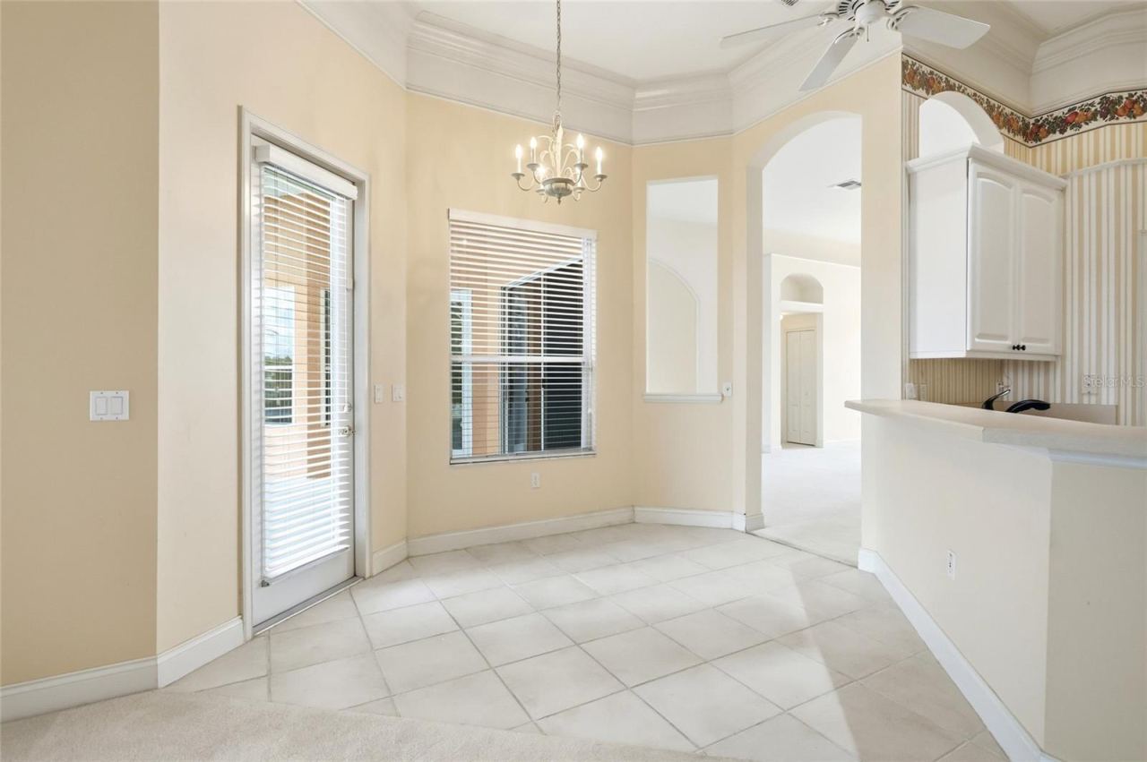 Photo 11 of 20: Windowed breakfast nook beside the kitchen, with direct access to the covered back porchand pool area.