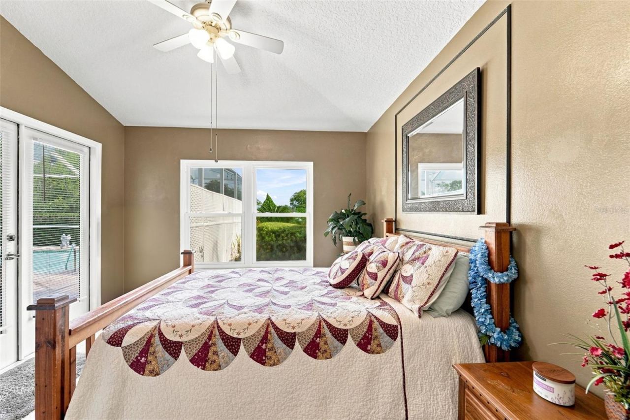 Photo 19 of 20: Second bedroom with private access to the covered lanai and pool via the French doors!