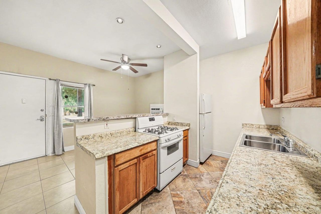 Photo 10 of 20: Open Kitchen Layout with Island, Gas Range & Access to Backyard