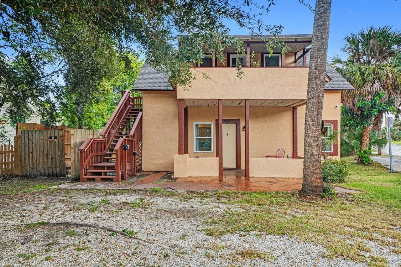 Photo 1 of 20: Two-Story Home With Brick Steps, Red Railings & Mature Trees