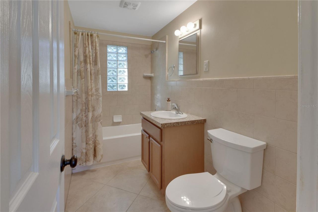 Photo 16 of 20: Spacious bathroom with tiled walls and new toilet