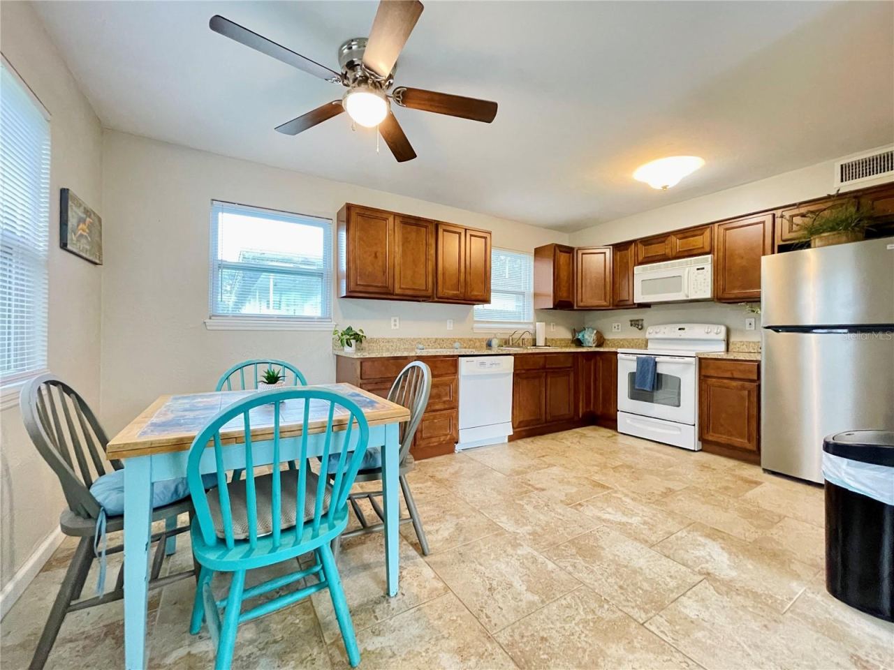 Photo 11 of 20: Natural light fills this inviting eat-in space, offering plenty of room for casual dining while keeping the kitchen close at hand.