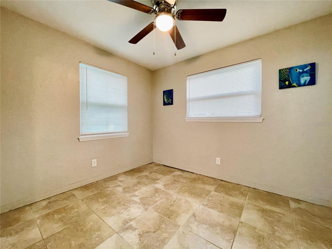 Photo 20 of 20: Natural light from two windows brightens this versatile guest bedroom, complemented by a ceiling fan for added comfort.