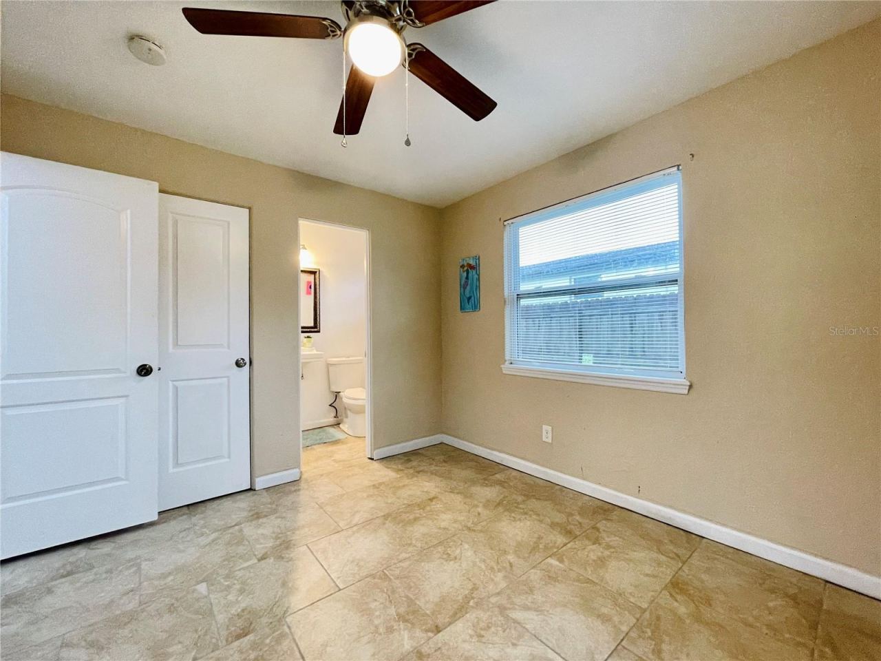 Photo 15 of 20: Another view of the bright bedroom with neutral colors and ceiling fan.