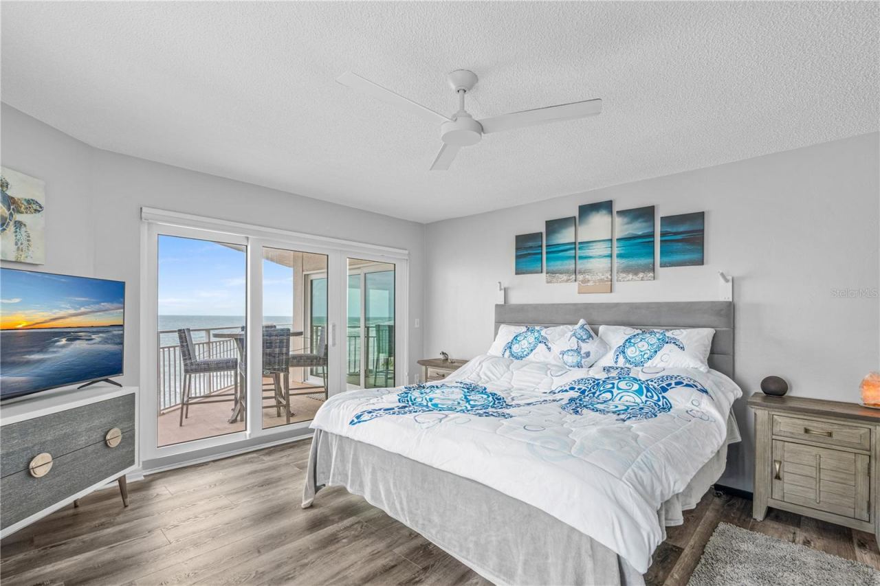 Photo 15 of 20: Primary Bedroom with Sliders to Balcony