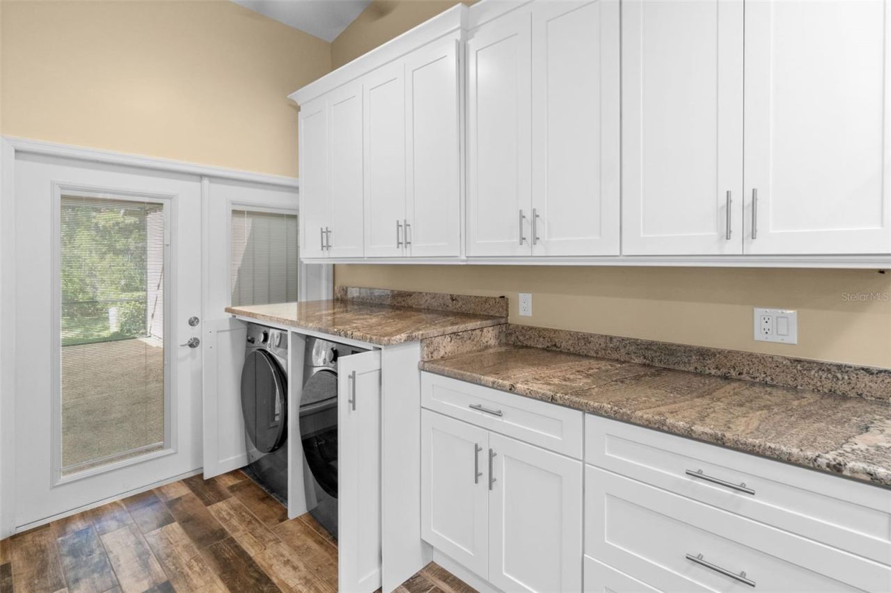Photo 16 of 20: laundry/kitchen storage and doors leading to the lanai