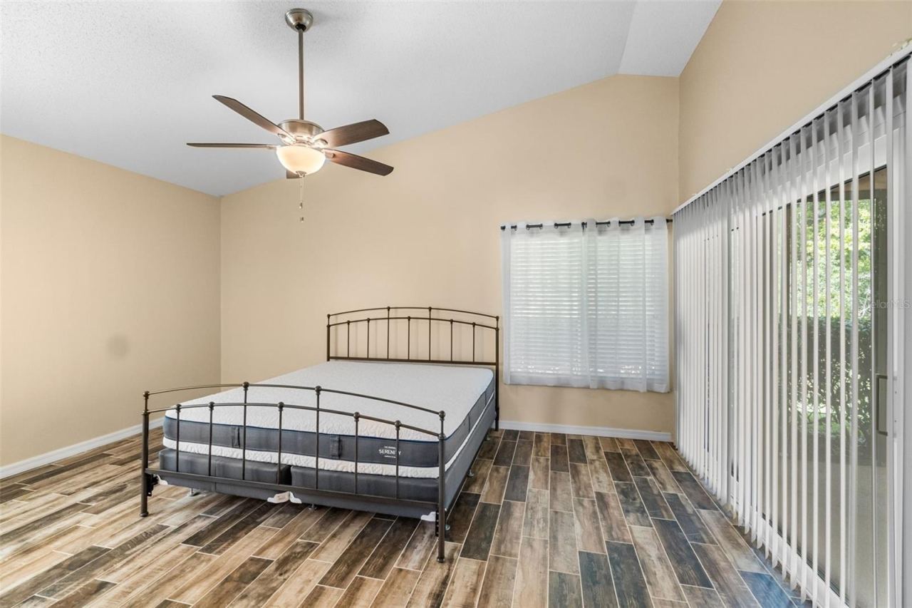Photo 20 of 20: main bedroom with king sized bed and sliders to screened lanai