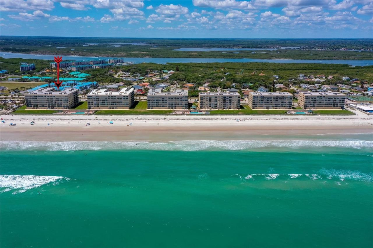 Photo 4 of 20: Stunning overhead view emphasizing the building’s direct beachfront location with expansive ocean vistas.
