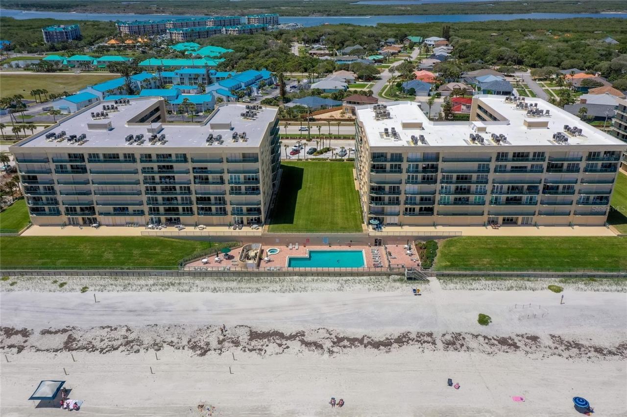 Photo 1 of 20: Resort-style pool and spa area situated just steps from the sand, offering a relaxing setting with ocean views.
