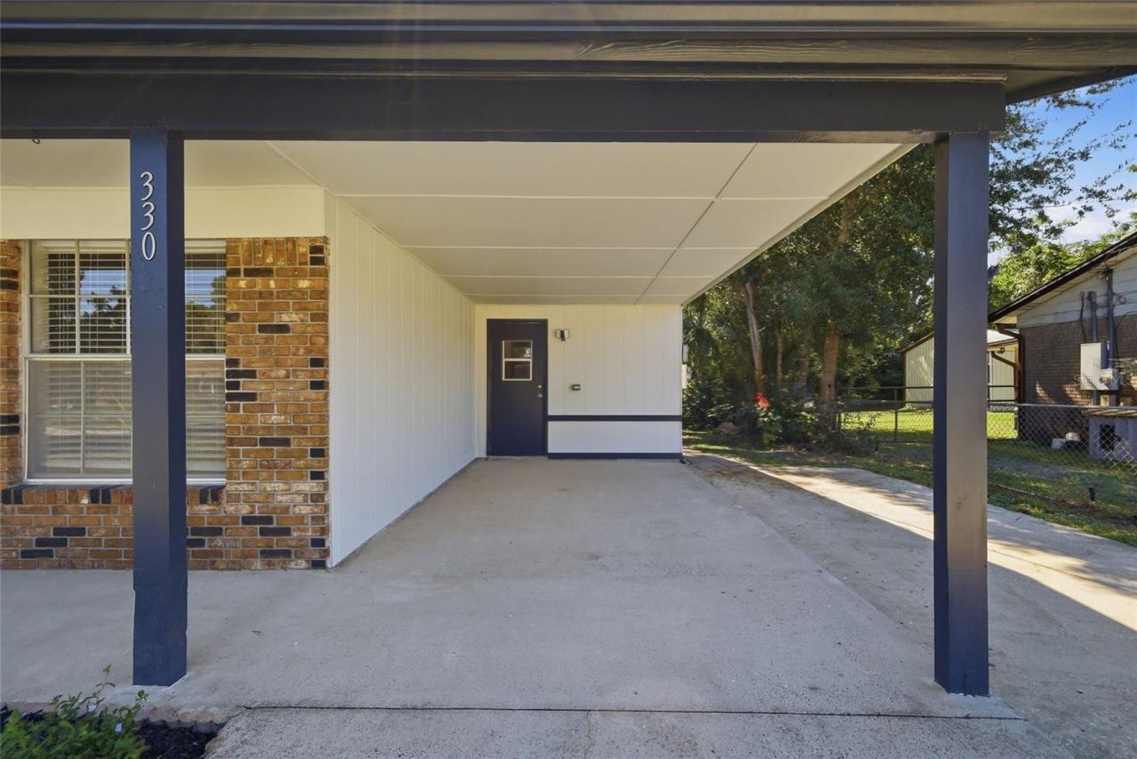 Photo 5 of 20: Carport with door to interior utility room.