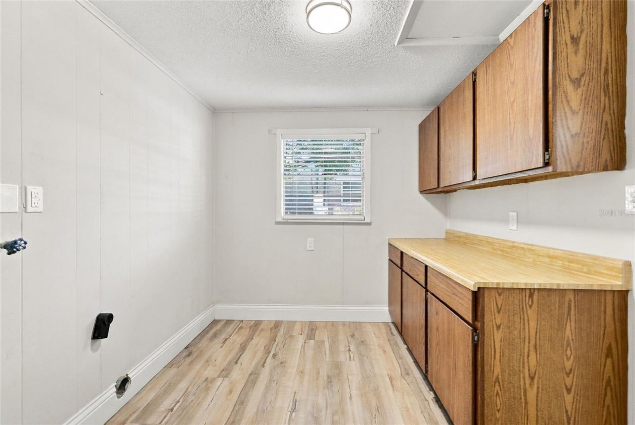Photo 17 of 20: Inside utility with washer and dryer hookups.