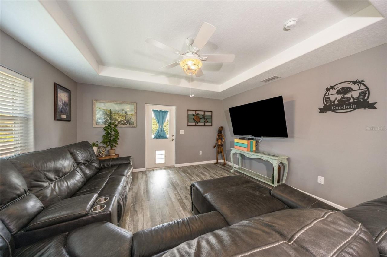 Photo 4 of 20: Family room with tray ceiling & the door leading to front deck