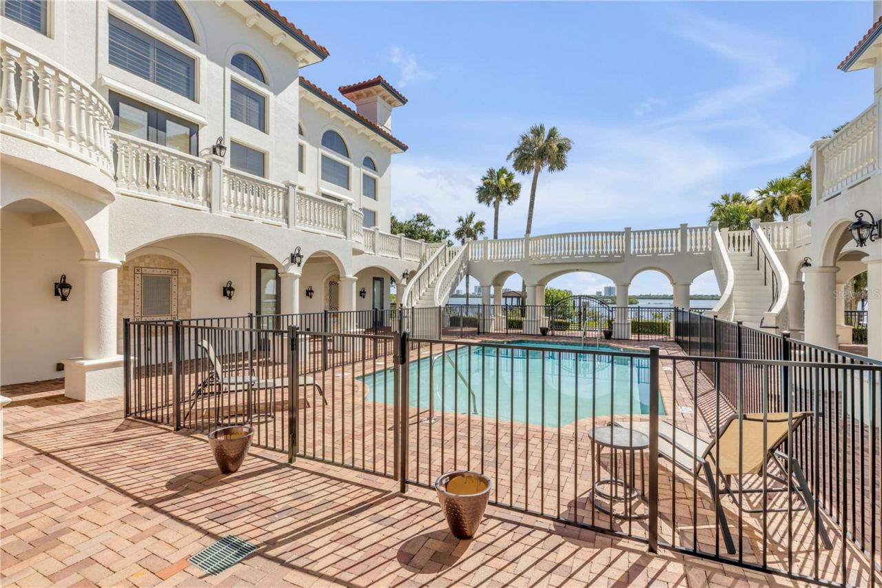 Photo 16 of 20: Common Balcony with dual curved staircases coming toward the pool area.
