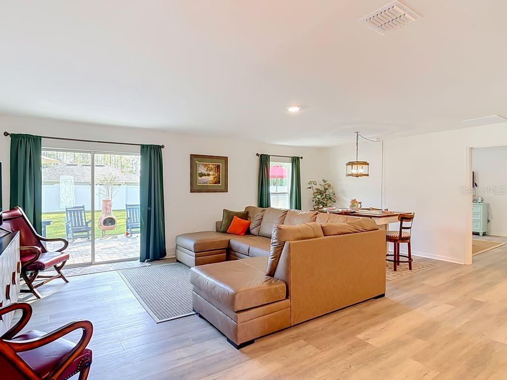 Photo 5 of 20: Family room -luxury vinyl flooring View to dining room and sliders to outdoor oasis