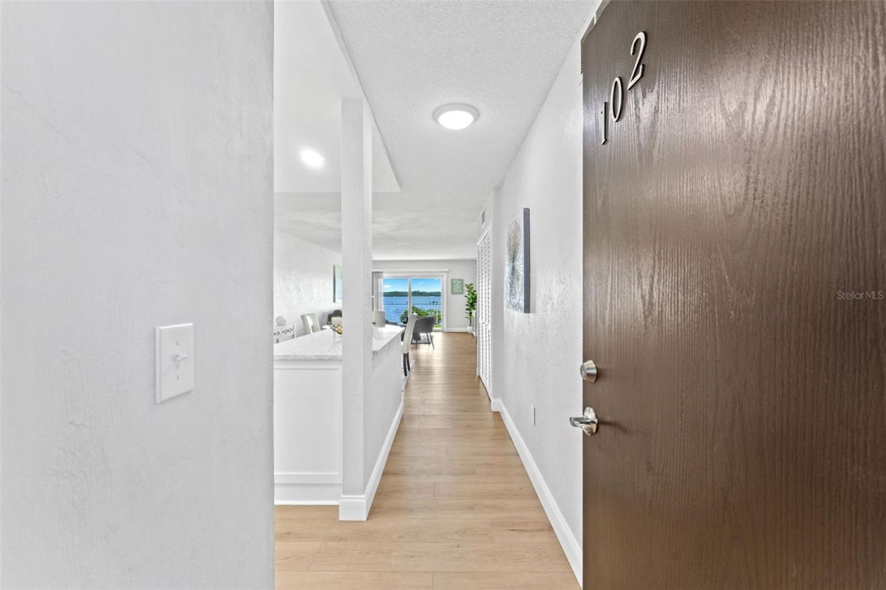 Photo 3 of 20: Welcome to unit #102. Side, lobby and even back patio entry.