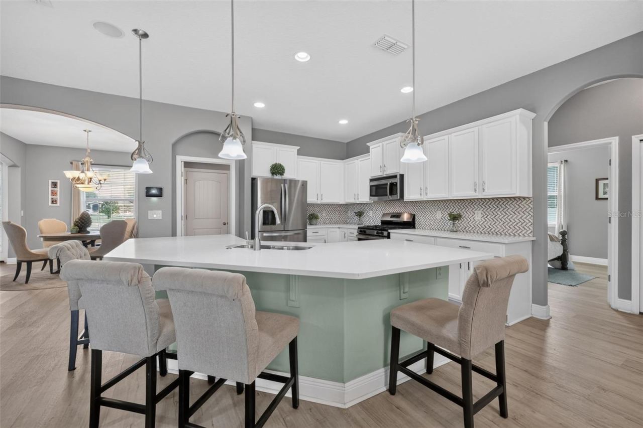 Photo 7 of 20: Breakfast bar overlooking this beautifully updated kitchen with quartz countertops