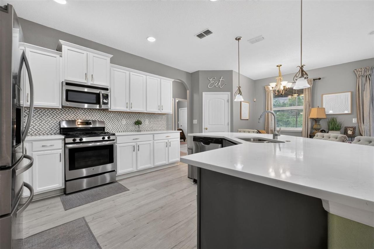 Photo 6 of 20: Kitchen with quartz countertops, island at right.