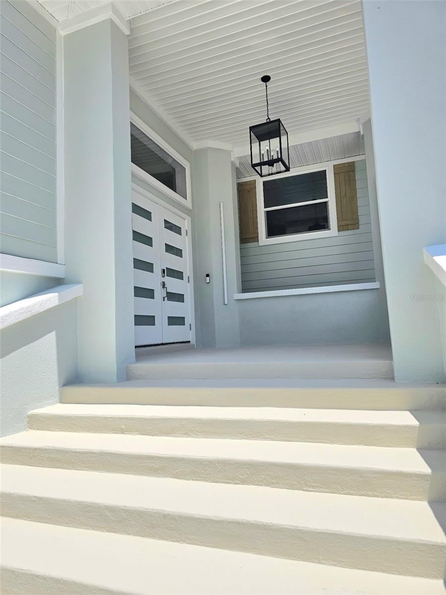Photo 6 of 20: Huge covered patio leading to the entrance with glass accents in the double doors