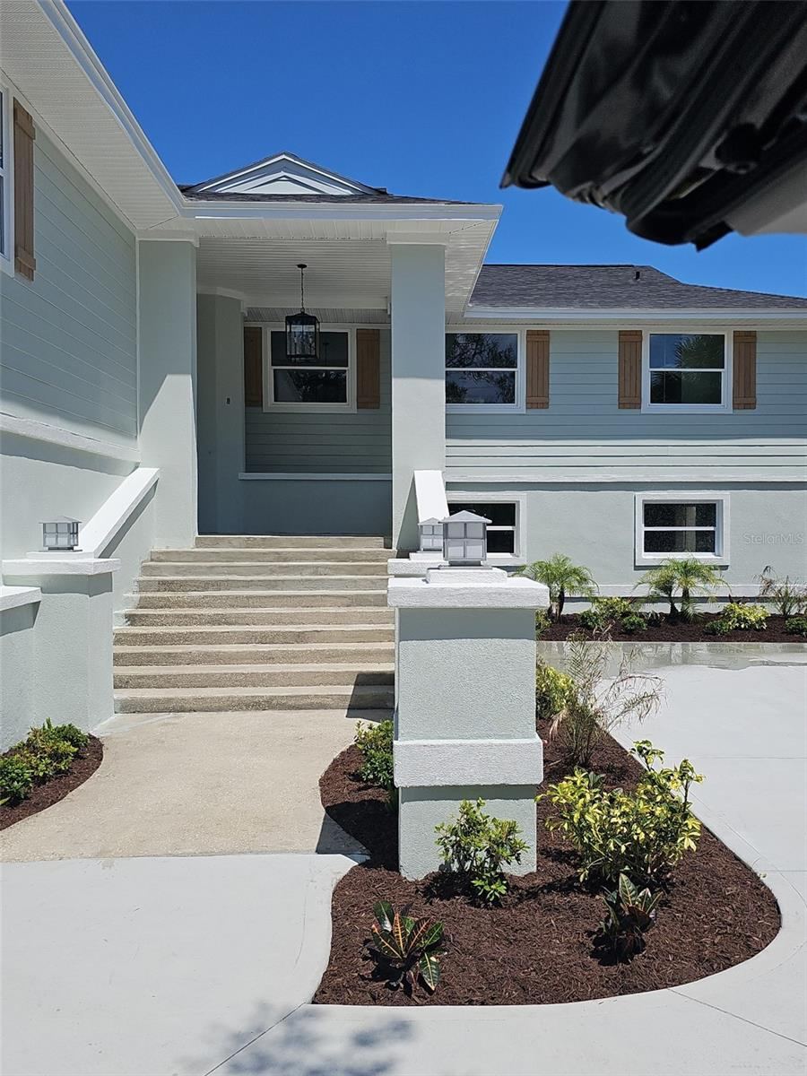 Photo 5 of 20: Closer view of front of home with parking pad