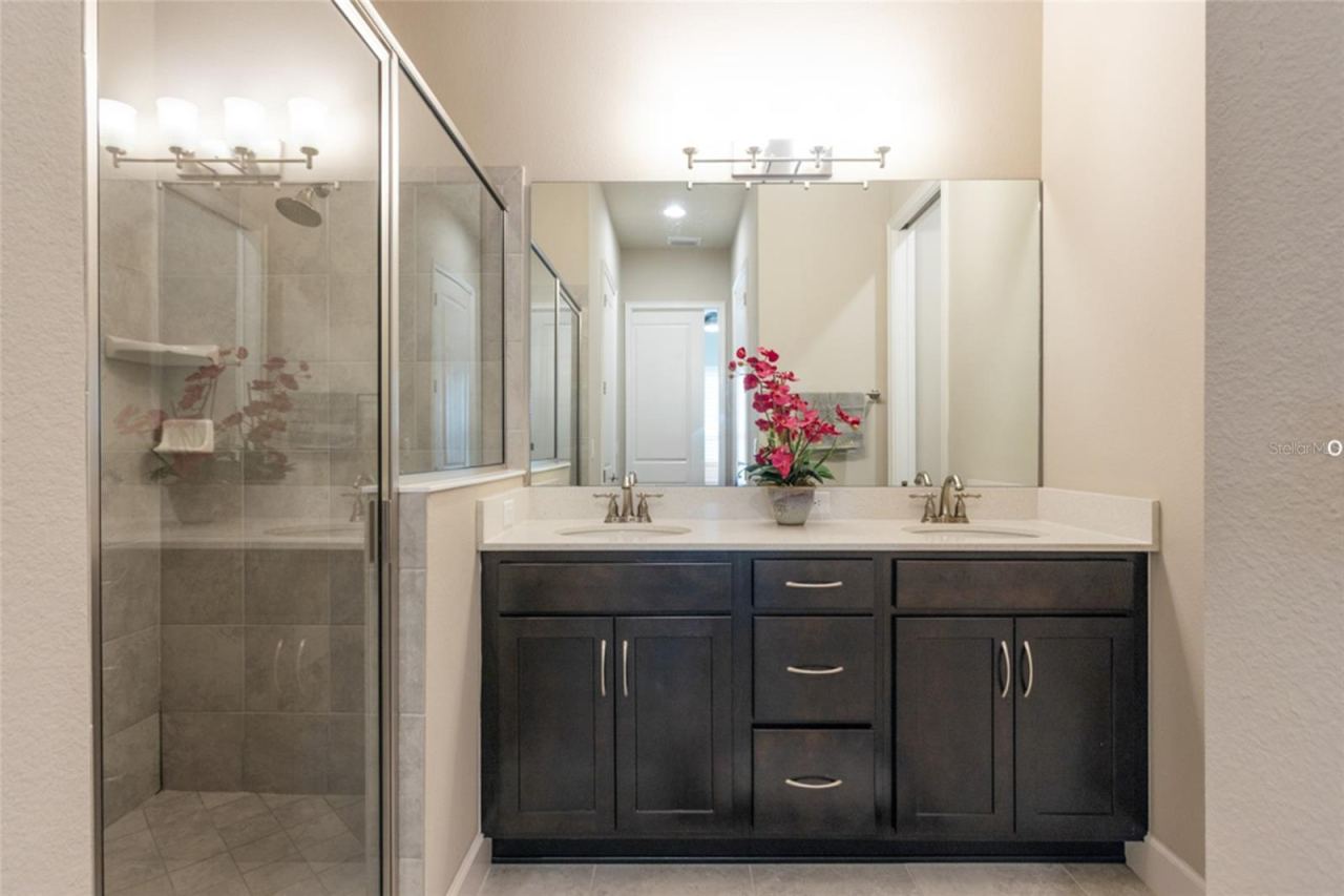 Photo 19 of 20: Primary bath with double vanities and large shower