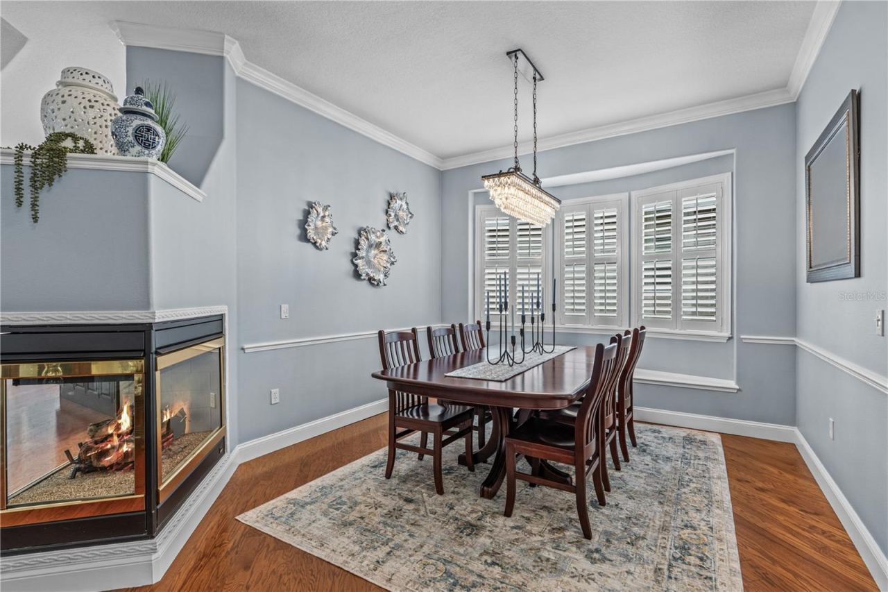 Photo 11 of 20: Dining room with decorative chair rail and window seat (behind the table); The fireplace is natural gas and adds warmth & ambiance