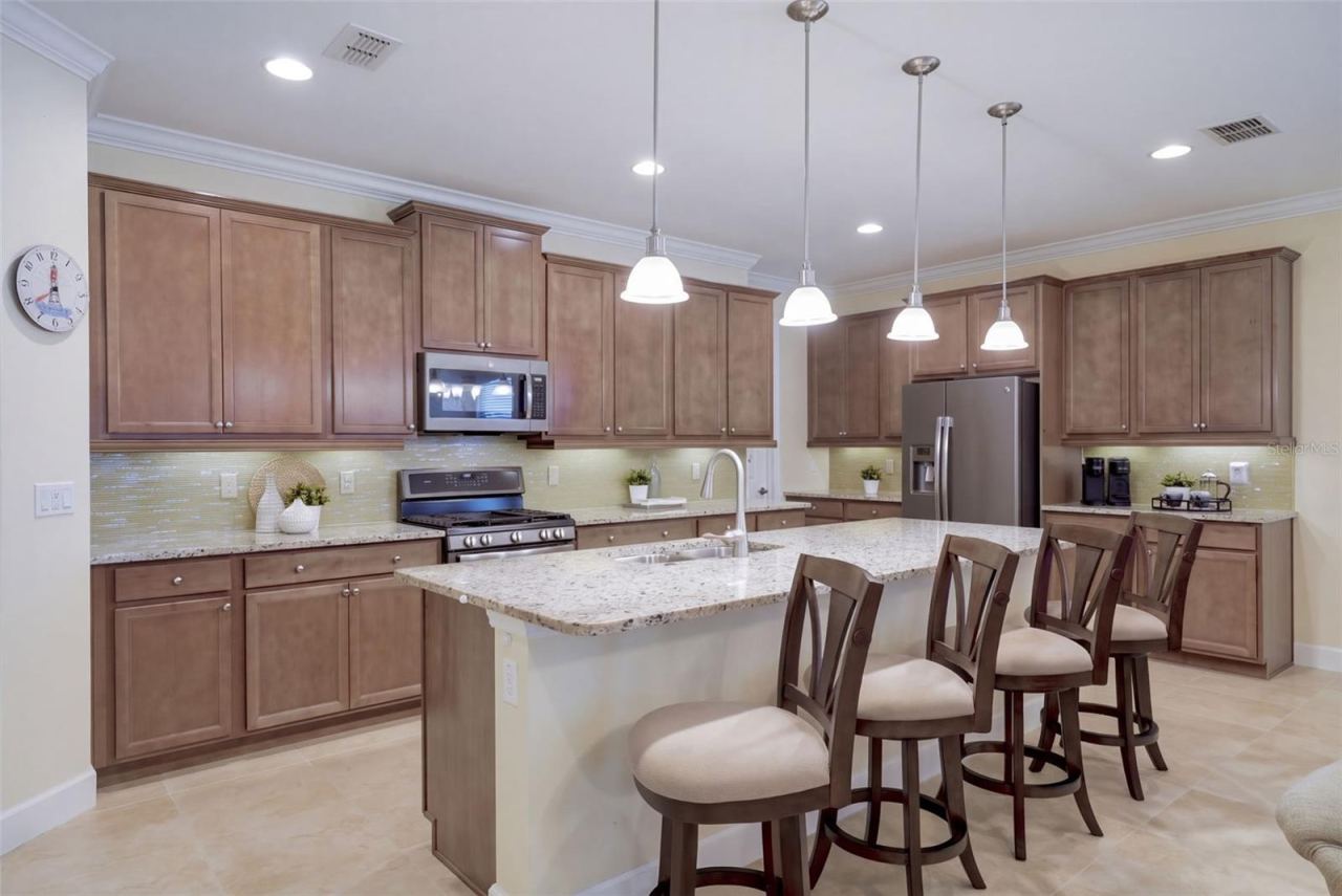 Photo 5 of 20: 19' x 10' Kitchen w/ 42" cabinets, under cabinet lighting, Listello backsplash & granite countertops