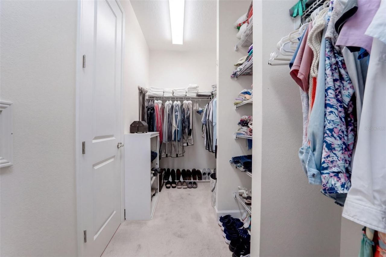 Photo 19 of 20: 14' x 5'6" Walk-in closet for Primary Bedroom