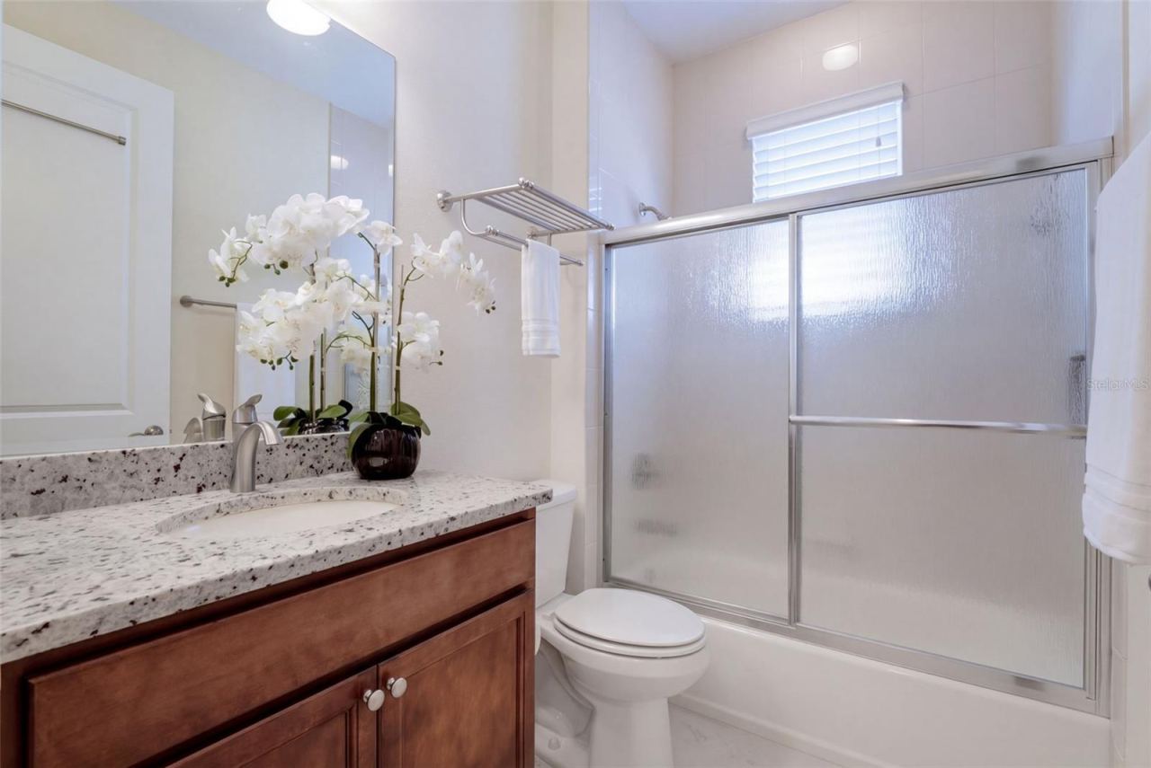 Photo 20 of 20: Guest Bathroom w/ granite countertop vanity & Tub/Shower combo w/ sliding glass enclosure
