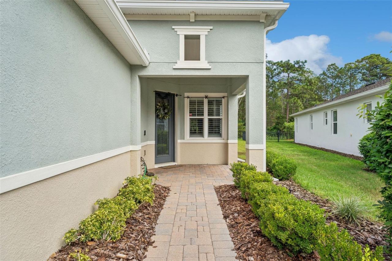 Photo 2 of 20: Front entry walkway w/ front porch & leaded glass front door