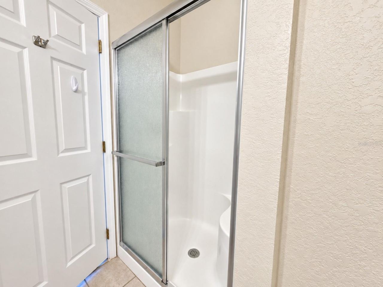 Photo 11 of 20: Primary Bathroom - walk-in shower with built in bench
