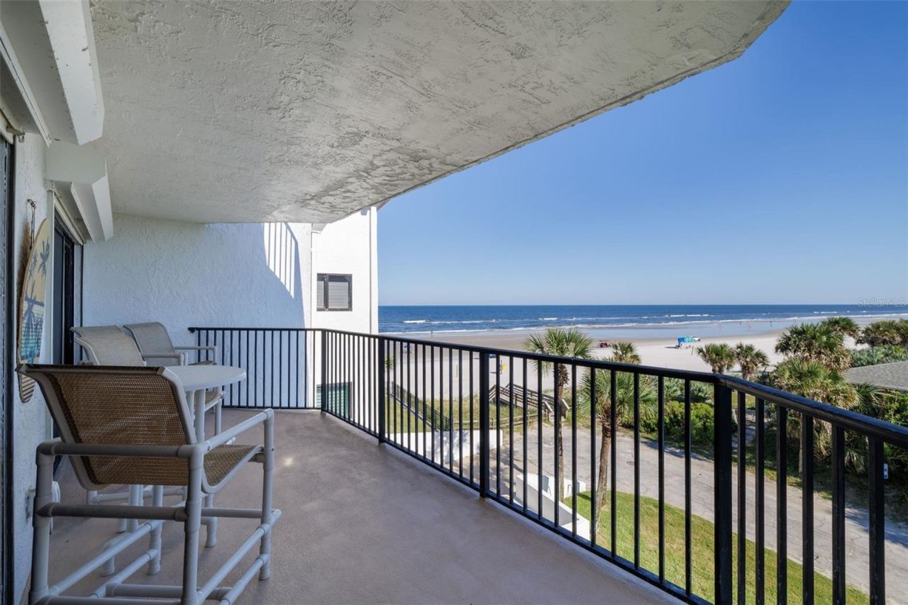 Photo 3 of 20: Spacious balcony overlooks the sandy beach & spectacular sunrises & sunsets.