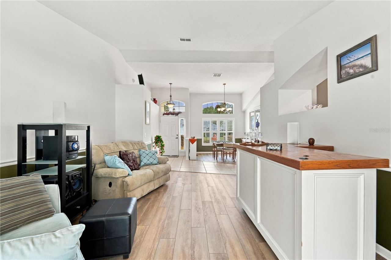 Photo 6 of 20: Looking from pool area towards front door and showing living room and dining room.