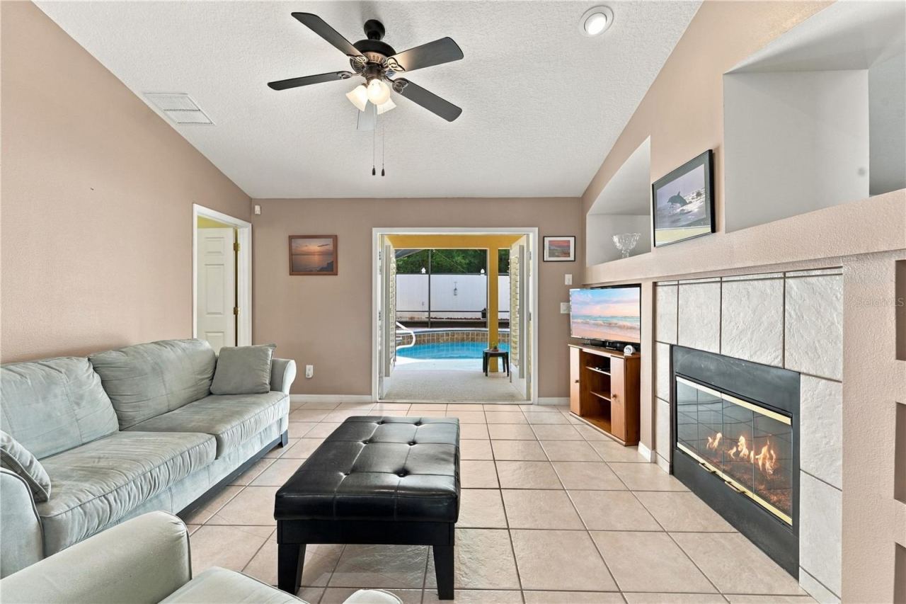 Photo 9 of 20: Separate family room with built in shelves and wood-burning fireplace