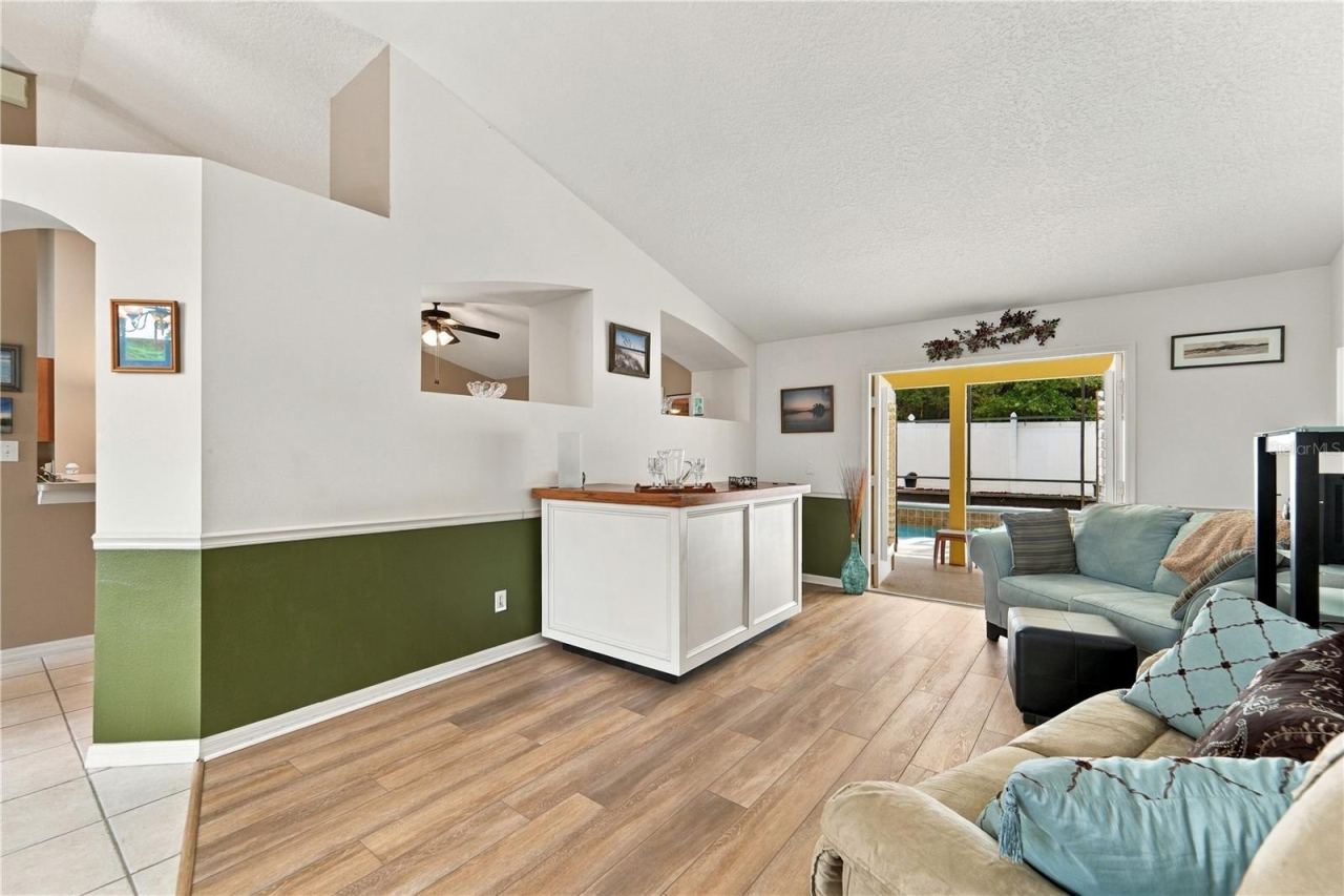 Photo 4 of 20: Living room with French doors out to the pool and screened porch