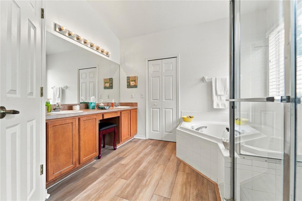 Photo 17 of 20: Primary bathroom with double sinks, tub and shower.