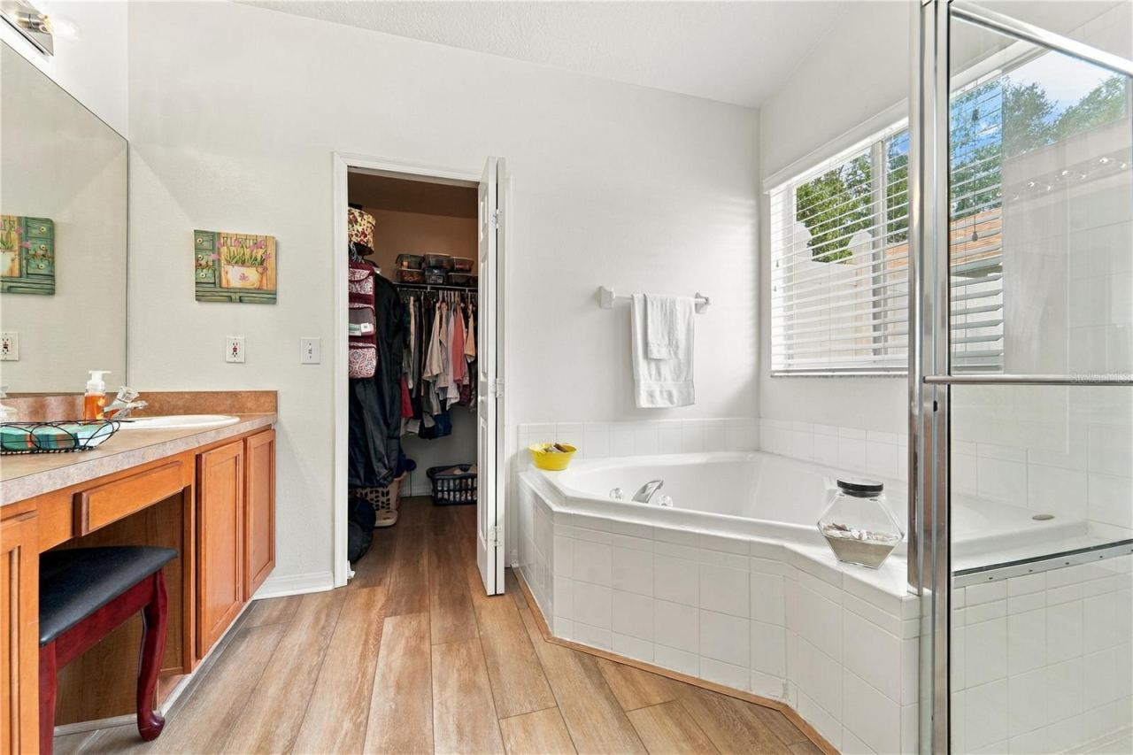 Photo 19 of 20: Primary bathroom with seating area and walk-in closet